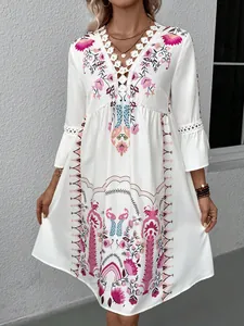 Detail view of boho V-neck dress featuring intricate lace crochet and vibrant floral prints