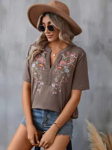 Detailed view of a fashion women's t-shirt with floral embroidery and lace trim