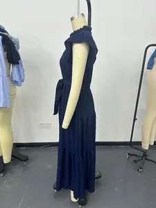 Side profile of a navy blue textured maxi dress featuring flutter sleeves and a waist tie