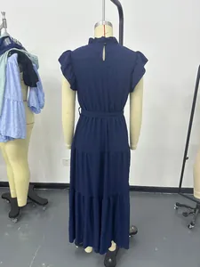 Detailed back view of a navy blue tiered maxi dress with ruffled sleeves on a mannequin
