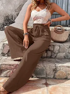Elegant brown bubble crepe wide-leg pants featuring a high-waisted drawstring design