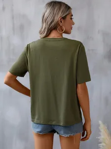 Rear view of a stylish olive green short-sleeved T-shirt against a textured grey wall