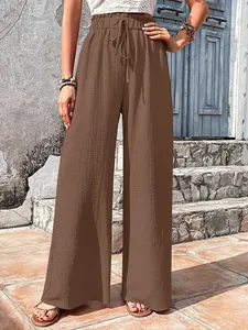 Close-up detail of brown bubble texture high-waisted wide leg casual pants for women