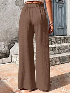 Back view of brown bubble grid high-waisted wide-leg casual pants with ruffled waist.