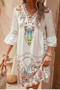 Close-up of V-neck lace-up detailing on white floral print boho dress