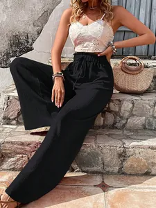 Detail view of black bubble textured wide-leg trousers with high waist drawstring.