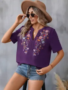 Detailed view of fashionable purple summer top with intricate floral embroidery