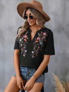 Close-up showing the intricate floral embroidery and lace trim on this black T-shirt