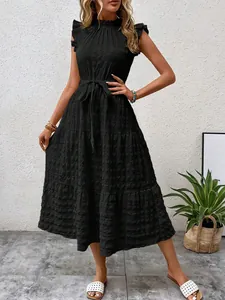 Detailed view of black summer midi dress featuring ruffle sleeves and tie-waist textured fabric