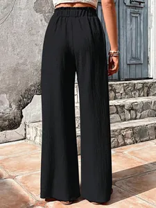 Detailed back view of fashionable black bubble crepe wide-leg pants with elastic waist