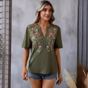 Elegant women's olive green V-neck top featuring vibrant floral embroidery and lace trim.