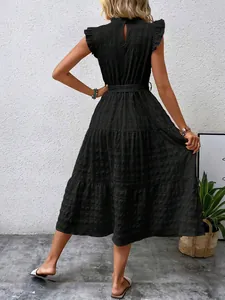 Back view of a black summer textured dress with ruffle sleeves and tiered skirt