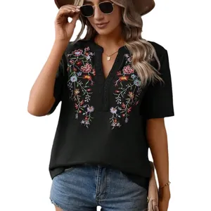 Women's black V-neck top with colorful floral embroidery and delicate lace trim.