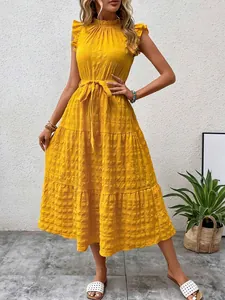Detailed view of an elegant yellow ruffled sleeveless textured maxi dress with waist tie