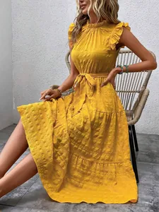 Elegant yellow summer dress featuring textured fabric, ruffle sleeves and a waist tie.