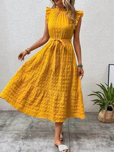 Yellow summer maxi dress featuring textured fabric, flutter sleeves, and a self-tie waist