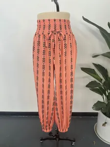 Peach patterned lantern pants with elastic drawstring waist and black geometric print
