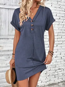 Close-up of casual blue V-neck dress featuring button details and stylish rolled sleeves