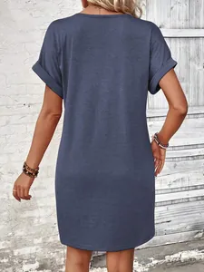 Back view of a stylish navy blue summer dress with rolled sleeves on a model