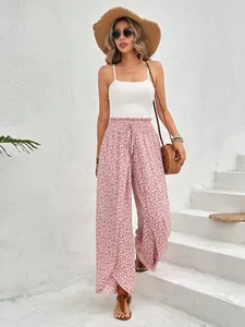 Elegant high-waisted floral wide leg pants with side slits shown on a model outdoors