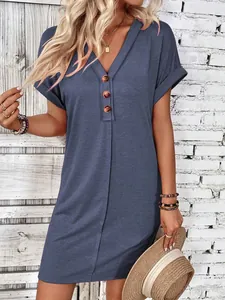Close-up of a stylish blue V-neck t-shirt dress with buttons and rolled sleeves