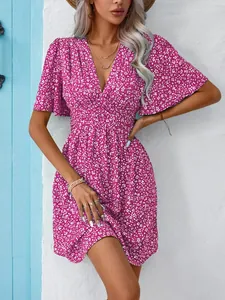 Detailed view of women's summer V-neck floral print high waist pleated pink dress.