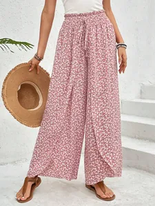 Close-up of pink floral wide-leg pants with a stylish side slit and elastic waist