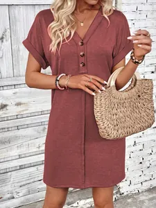 Detailed view of a dusty rose V-neck summer dress with buttons and rolled short sleeves