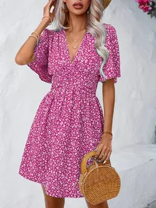 Close-up of a vibrant magenta floral print dress with high-waist and V-neckline
