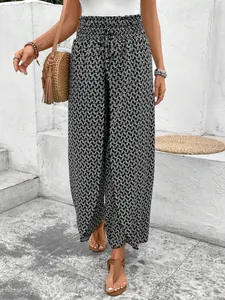 Detail view of high-waisted geometric print wide-leg trousers with side slits