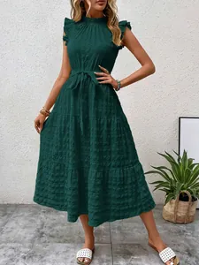 Detailed view of dark green textured dress with flutter sleeves and waist belt