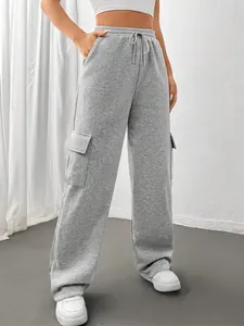 Detailed view of women's gray wide-leg cargo sweatpants featuring side flap pockets