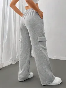 Detailed view of grey wide-leg cargo sweatpants featuring functional side flap pockets.