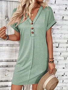 Detailed view of sage green V-neck dress with decorative buttons and rolled sleeves