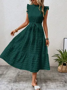 Detail view of dark green tiered maxi dress with ruffled sleeves and waist tie.