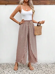 Stylish women summer floral side slit wide-leg pants with white tank top and straw bag