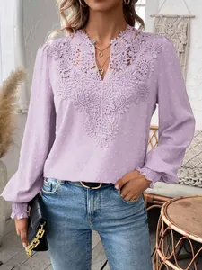 Close-up view of the intricate lace embroidery on this lavender V-neck long sleeve top