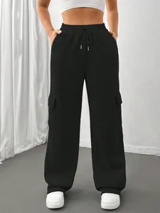 Detail of black wide-leg cargo sweatpants with drawstring waist and side pockets