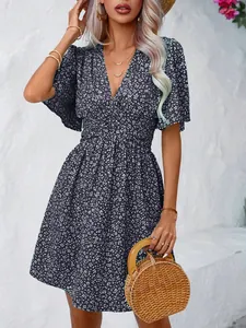 Detailed look at the V-neckline and floral print of this elegant high-waisted dress