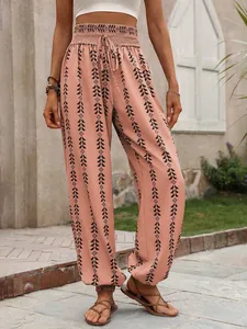 Detail view of peach bohemian printed harem pants with ethnic black geometric patterns