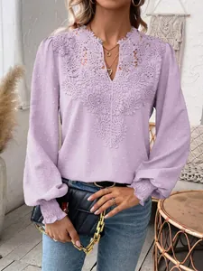 Close-up of elegant lavender V-neck lace blouse featuring smocked cuffs and stylish sleeves.