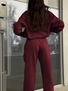 Back view of a stylish wine red two piece sweatshirt and joggers lounge set for women