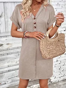 Close-up detail of a V-neck buttoned short sleeve casual summer dress in beige