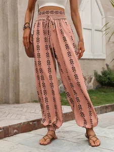Detailed view of bohemian high-waisted printed lantern pants with elastic smocked waist