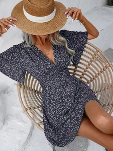 Detailed view of a navy floral V-neck dress with butterfly sleeves and high waist.