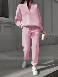 Close-up of a pink two-piece fleece leisure suit with half-zip sweatshirt and joggers