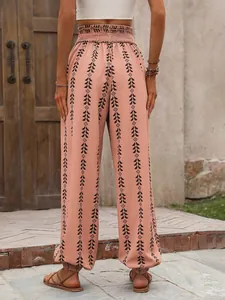 Casual bohemian peach patterned harem pants featuring elastic waist and ankle cuffs