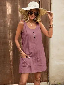 Close-up detail of mauve U-neck sleeveless dress featuring front buttons and pockets