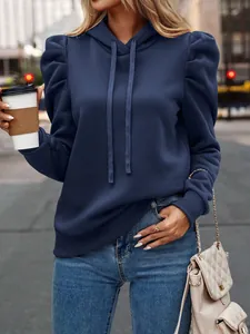 Stylish navy blue puff sleeve hoodie sweatshirt for women in casual urban setting.