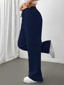 Detailed view of navy blue wide-leg cargo sweatpants with side pocket on a model